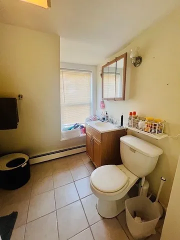 a bathroom with a toilet a sink and a mirror