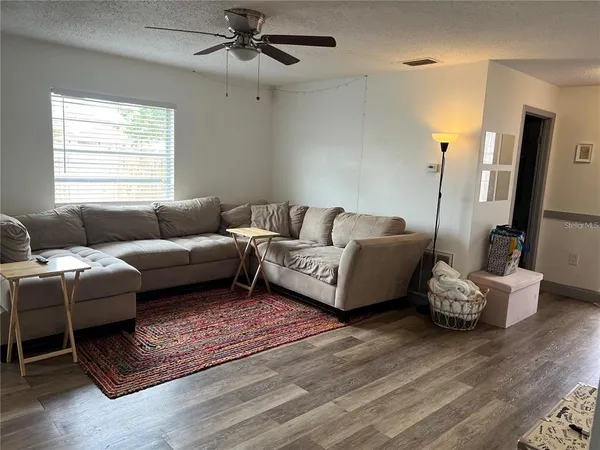 a living room with furniture rug and window
