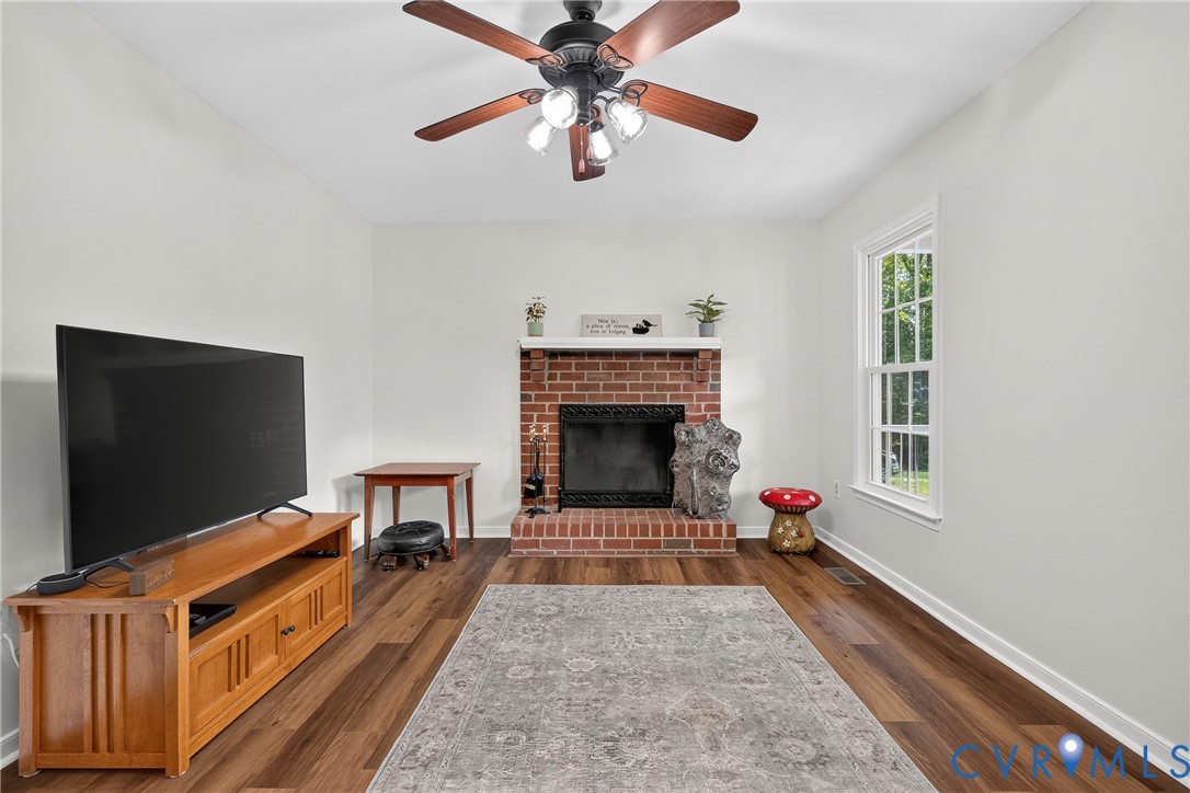 7248 Full Rack Drive Midlothian, VA 23112 - Photo 5 of 36 Vaulted ceiling with a ceiling fan, brick fireplac