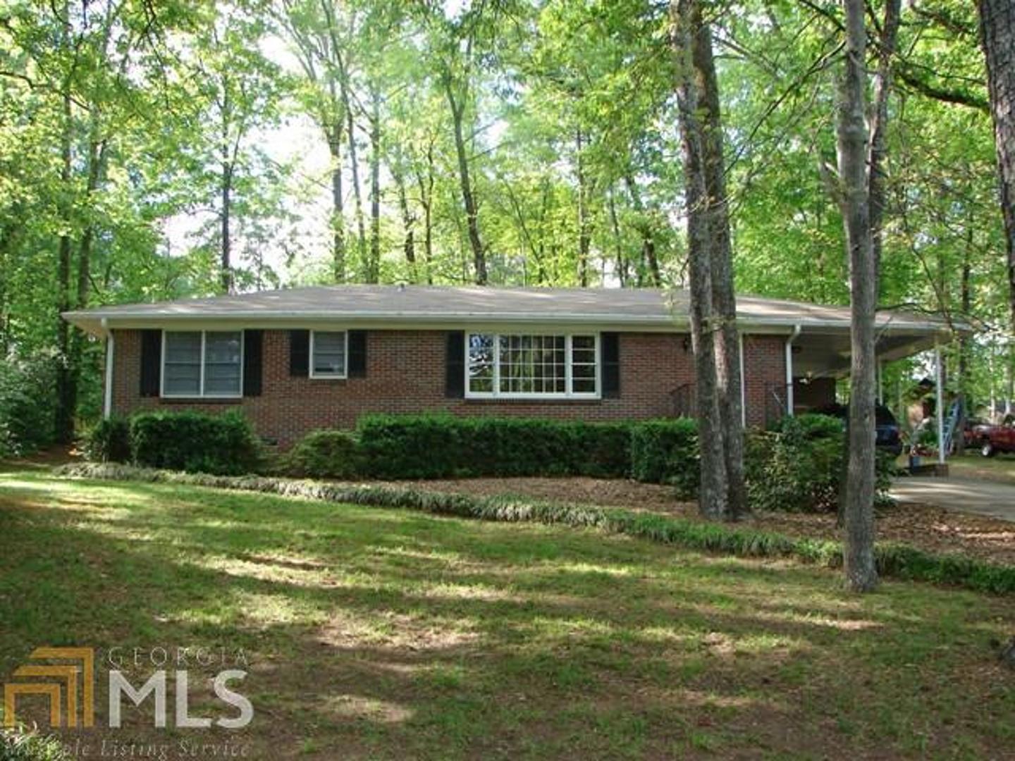 1071 East Atlanta Road, Unit 1 Stockbridge, GA 30281 - Photo 1 of 1 a front view of a house with a yard