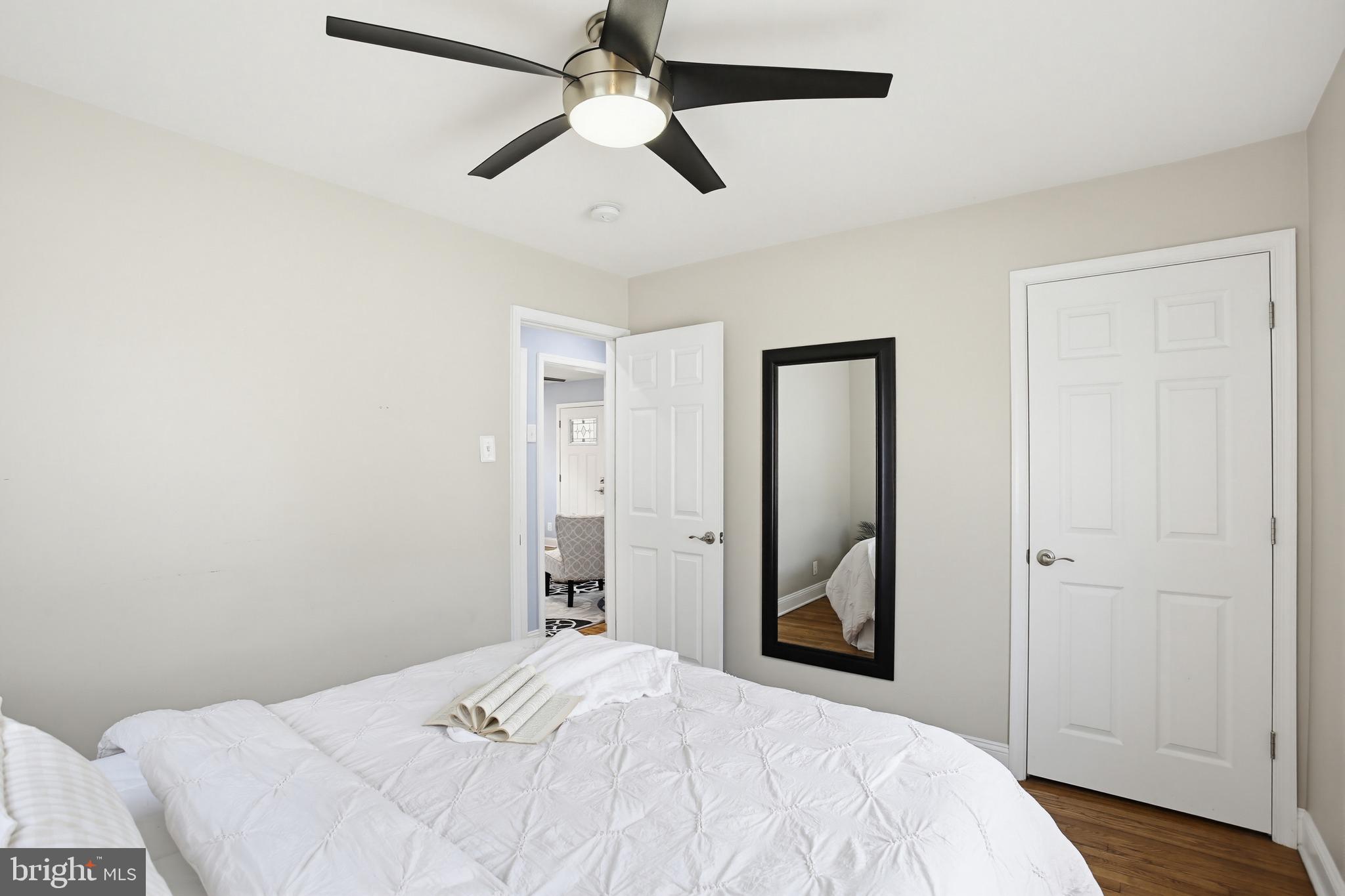 8209 Longpoint Road Baltimore, MD 21222 - Photo 15 of 37 a bedroom with a bed and a chandelier