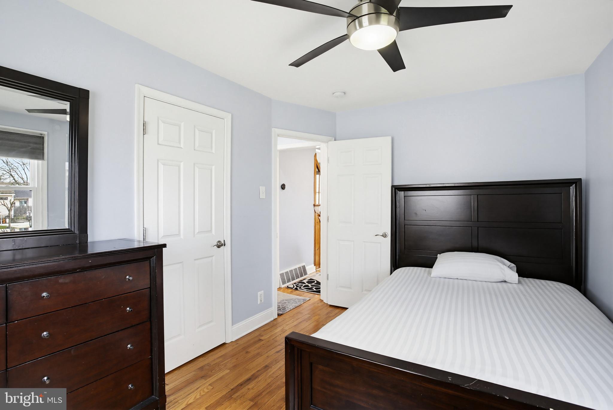 8209 Longpoint Road Baltimore, MD 21222 - Photo 17 of 37 a bedroom with a bed and a dresser