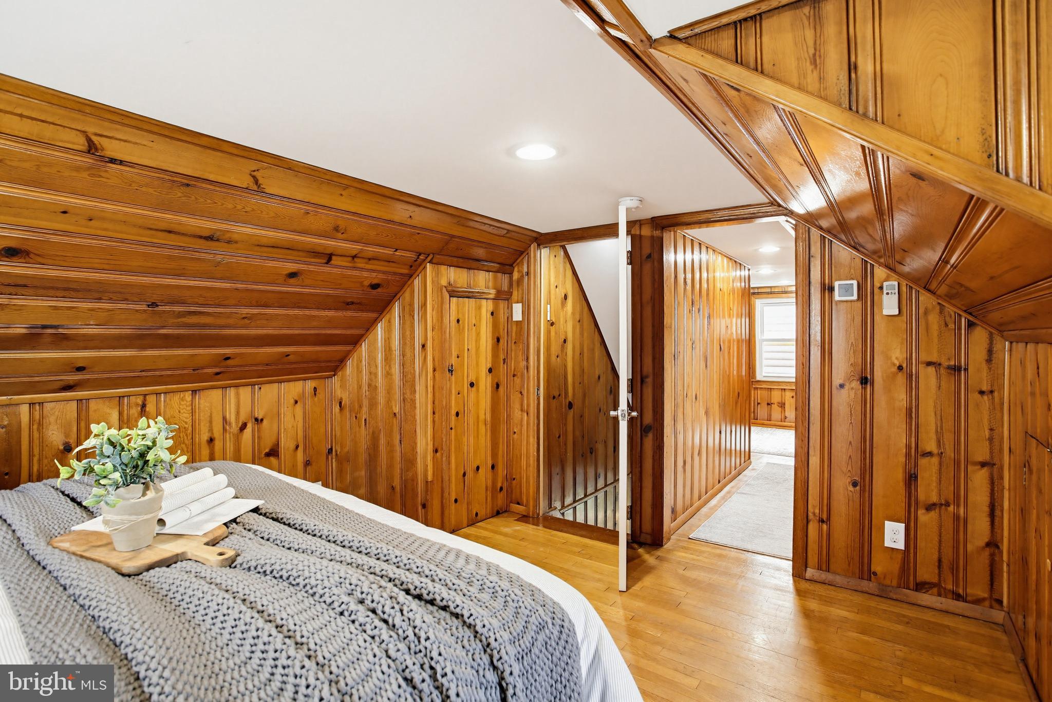 8209 Longpoint Road Baltimore, MD 21222 - Photo 21 of 37 a bedroom with a bed and a chandelier