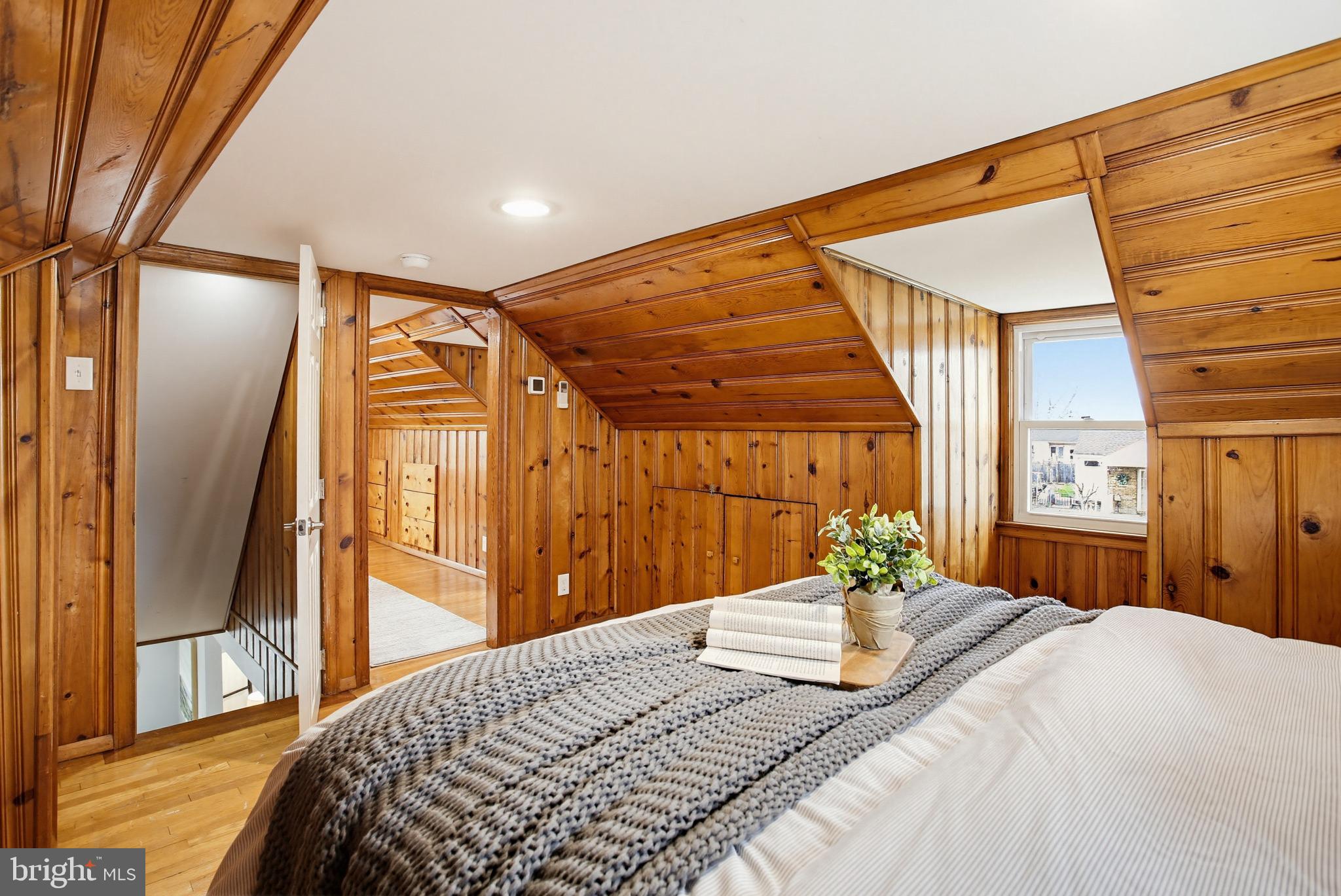 8209 Longpoint Road Baltimore, MD 21222 - Photo 23 of 37 a bedroom with a large bed and wooden floor