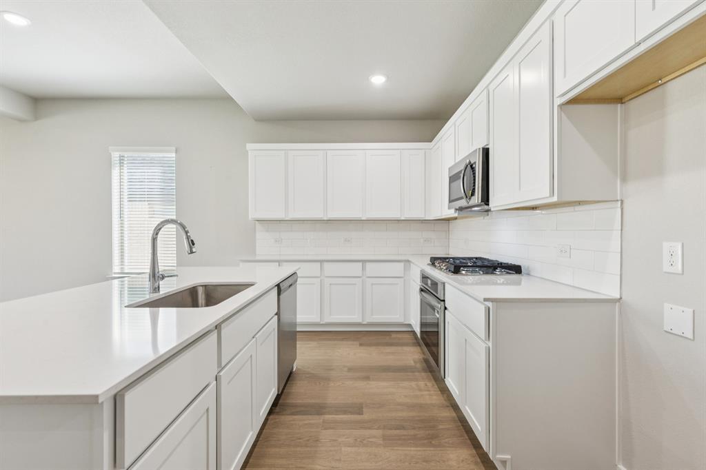 1464 Ranchero Rodeo Road Haslet, TX 76052 - Photo 8 of 33 Kitchen in the Stanley II home plan by Trophy Signature Homes – REPRESENTATIVE PHOTO