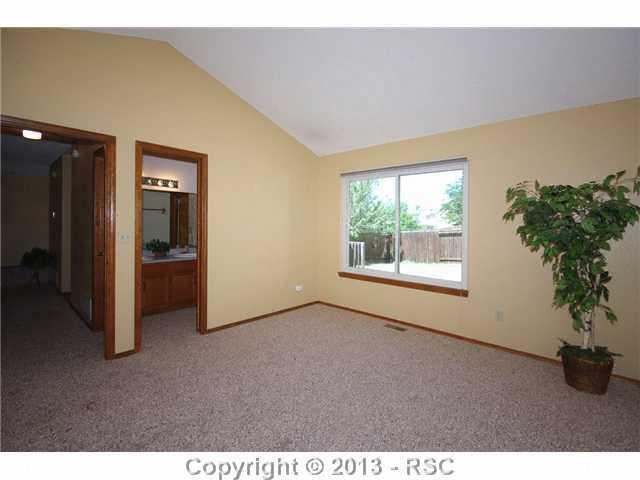 6630 Turkey Tracks Road Colorado Springs, CO 80922 - Photo 10 of 25 Master Bedroom with walk in to Bath