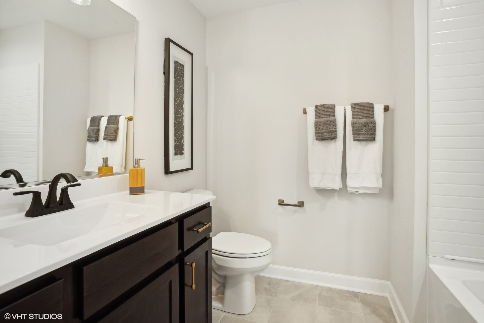 327 Masters Drive Addison, IL 60101 - Photo 13 of 16 a bathroom with a granite countertop sink toilet a mirror and vanity