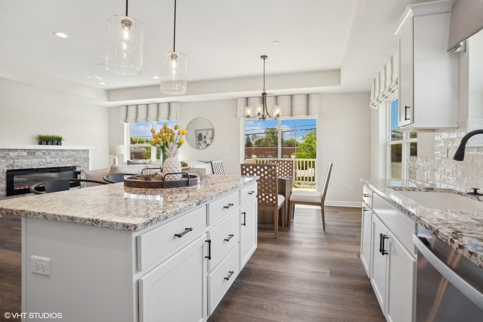 327 Masters Drive Addison, IL 60101 - Photo 6 of 16 a kitchen with stainless steel appliances granite countertop a sink dishwasher a stove and a dining table with wooden floor