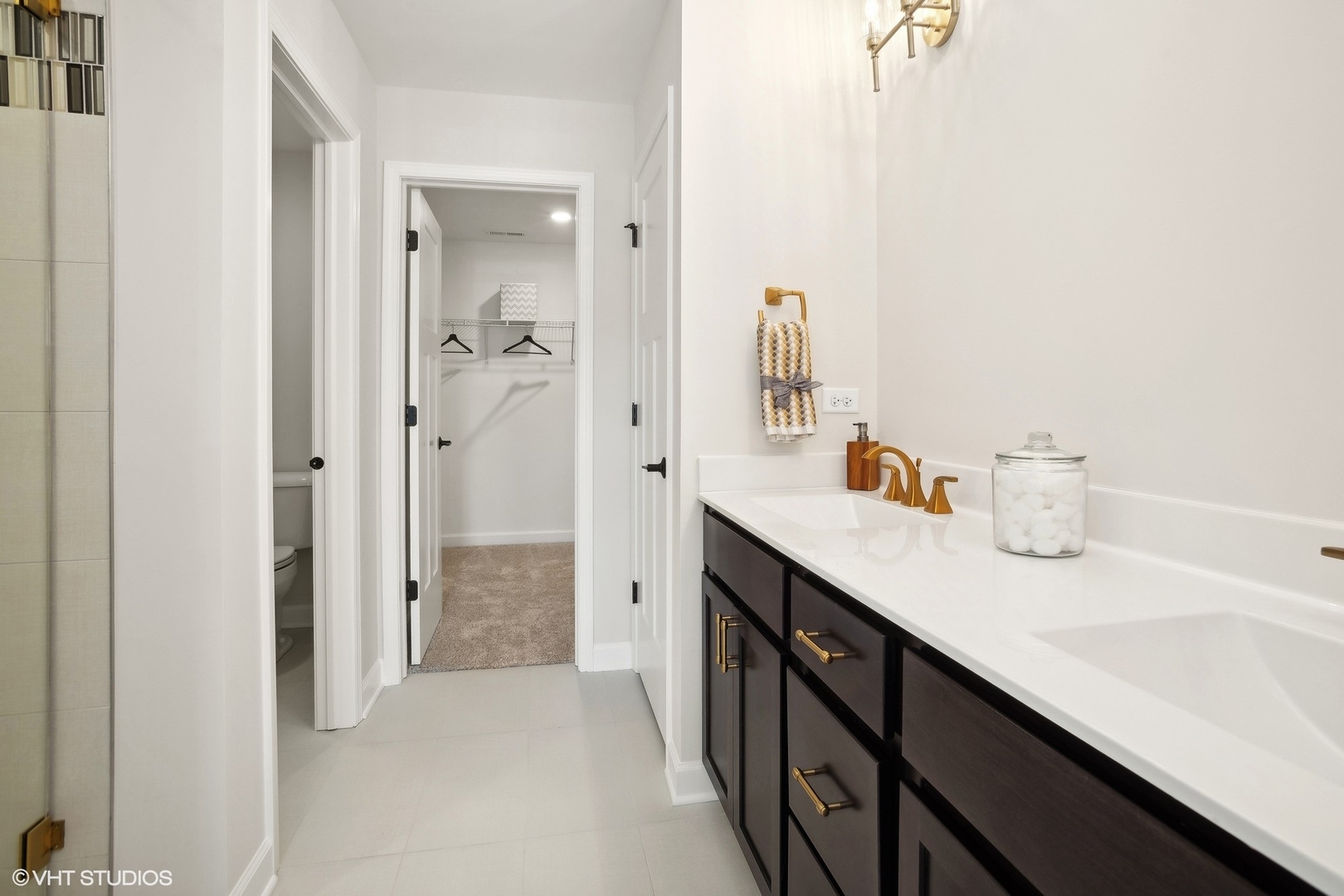 327 Masters Drive Addison, IL 60101 - Photo 9 of 16 a en suite bathroom with a double vanity sink a mirror and a shower