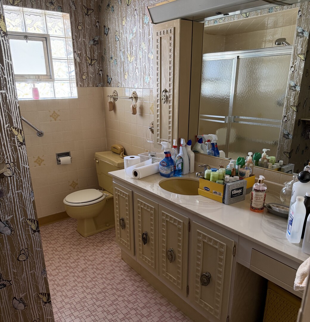 9037 Chester Avenue Niles, IL 60714 - Photo 11 of 12 a spacious bathroom with a double vanity sink toilet and a mirror