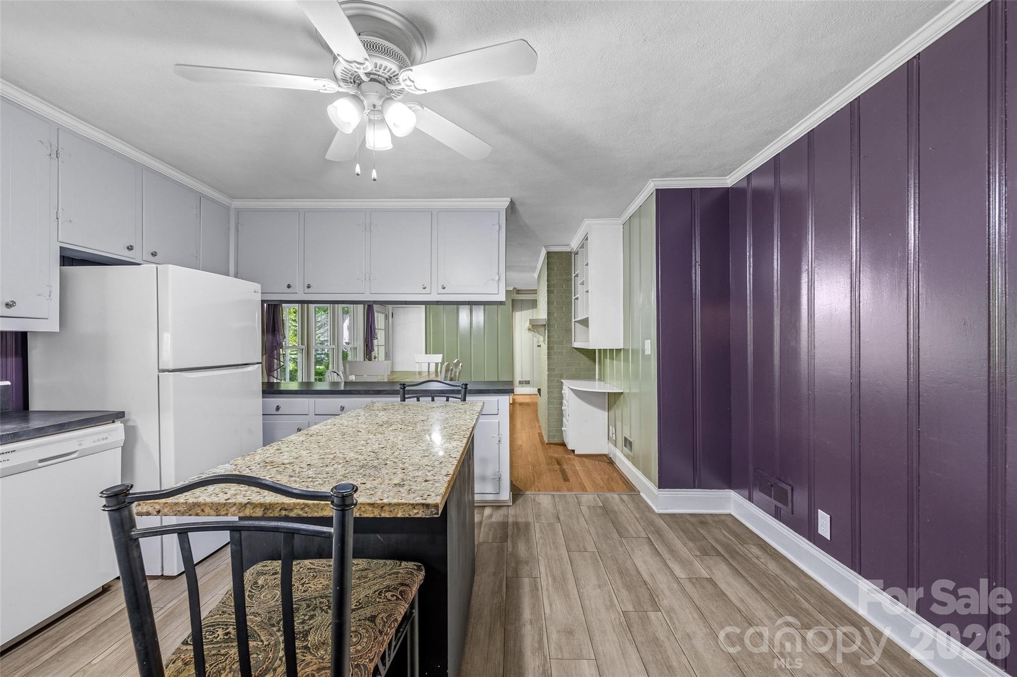 407 Pine Street Fort Mill, SC 29715 - Photo 15 of 45 a kitchen with stainless steel appliances granite countertop a refrigerator a stove a sink dishwasher and a dining table with wooden floor