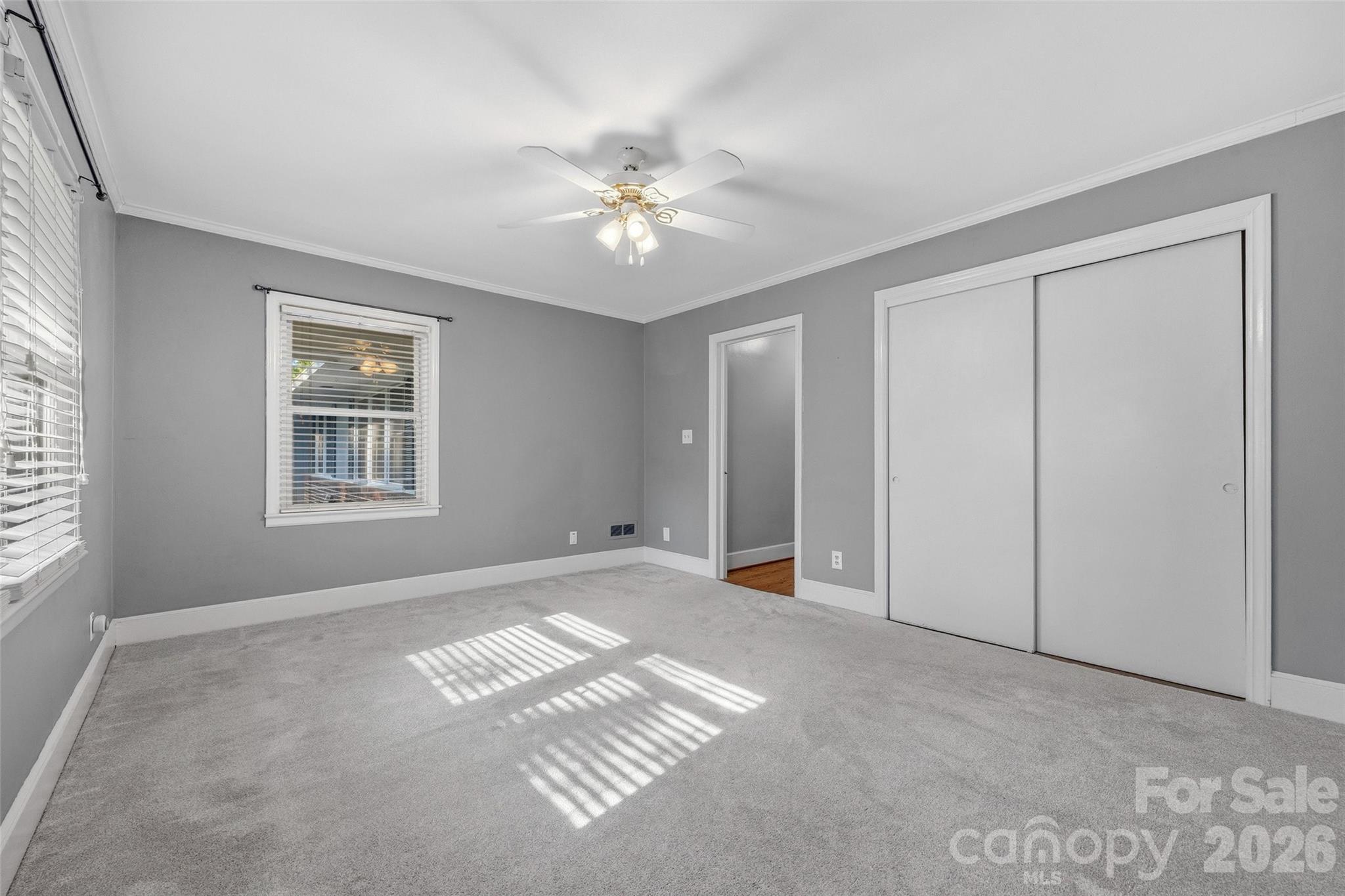407 Pine Street Fort Mill, SC 29715 - Photo 29 of 45 a view of an empty room with window and chandelier fan