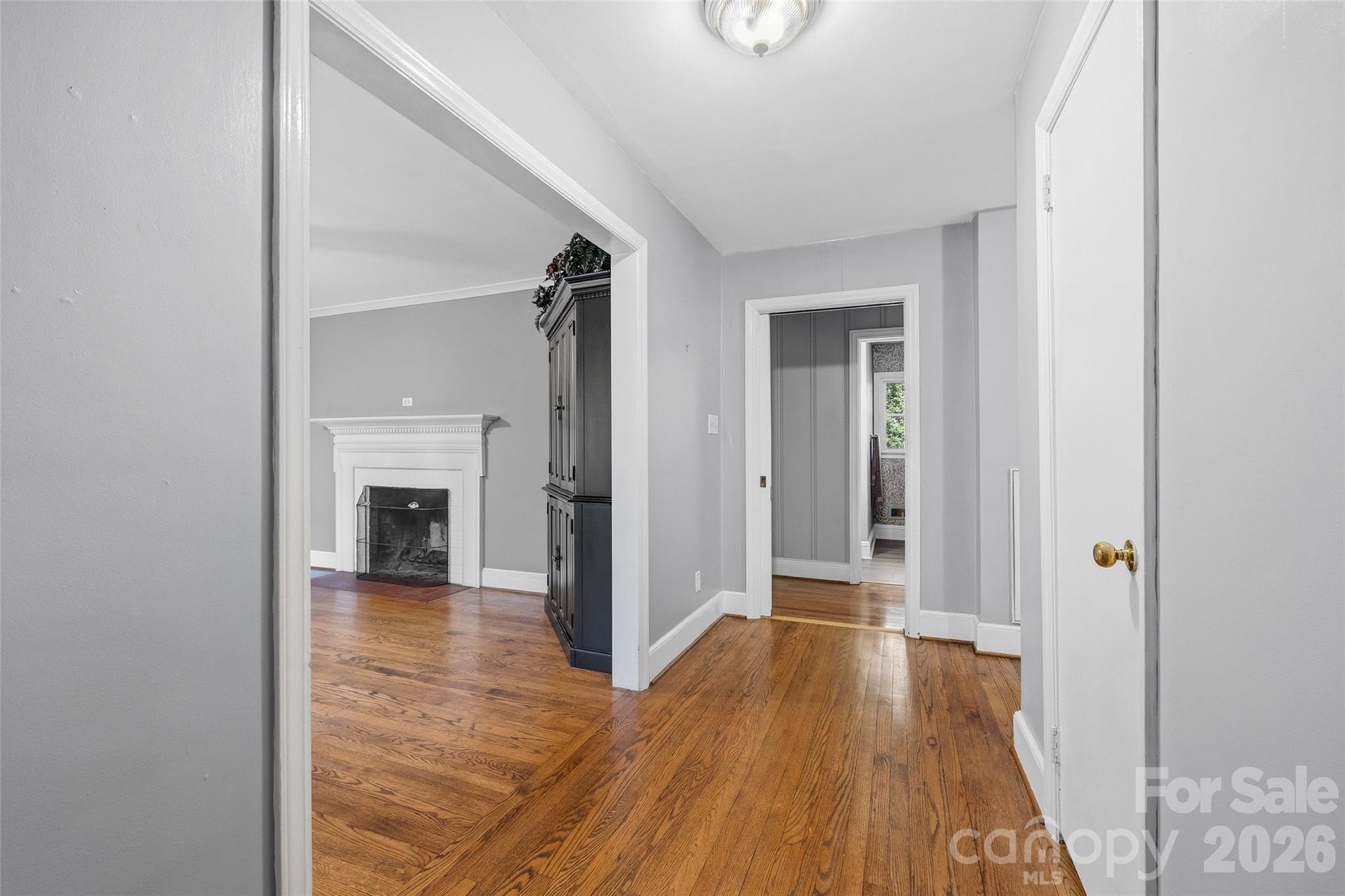 407 Pine Street Fort Mill, SC 29715 - Photo 6 of 45 a view of a hallway with wooden floor and a fireplace