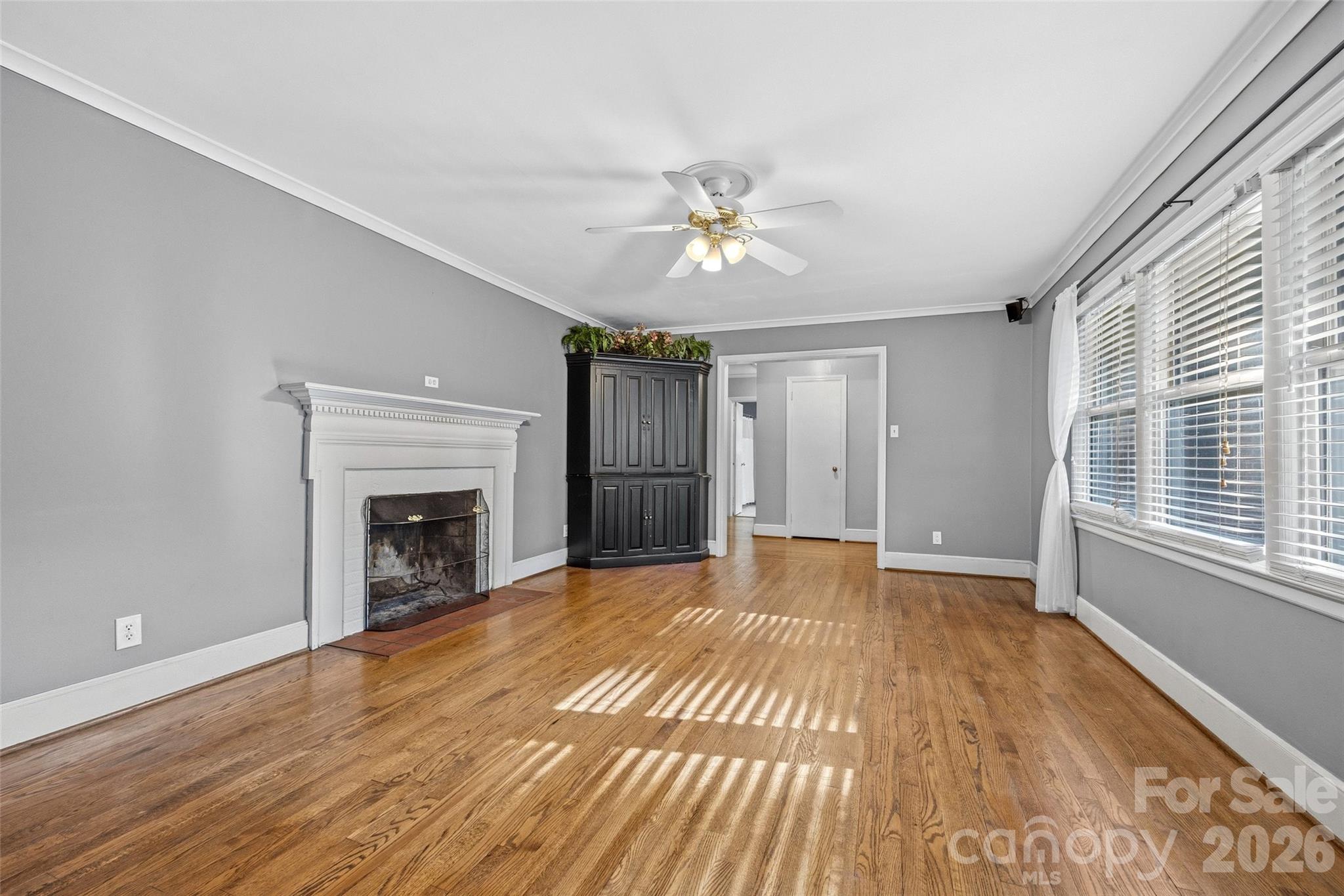 407 Pine Street Fort Mill, SC 29715 - Photo 8 of 45 a view of an empty room with a fireplace and a window