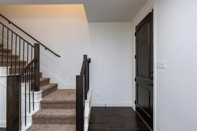 a view of entryway and gallery with wooden floor