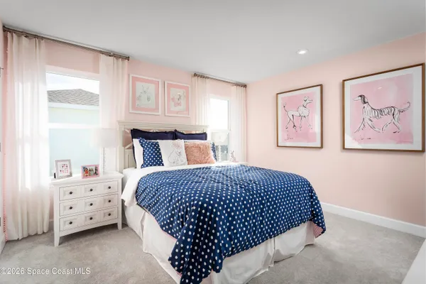 a bedroom with a bed and a painting on the wall