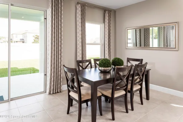 a view of a dining room with furniture and a potted plant