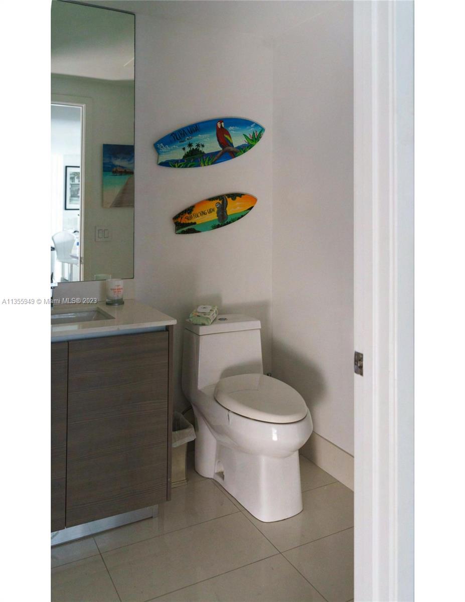460 Northeast 28th Street, Unit 808 Miami, FL 33137 - Photo 13 of 20 a bathroom with a sink a toilet and mirror