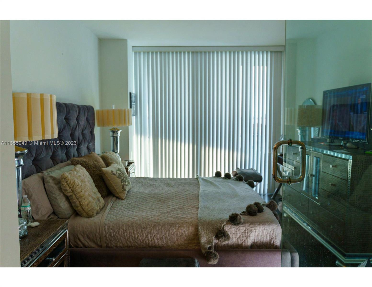460 Northeast 28th Street, Unit 808 Miami, FL 33137 - Photo 17 of 20 a bedroom with a bed next to a window