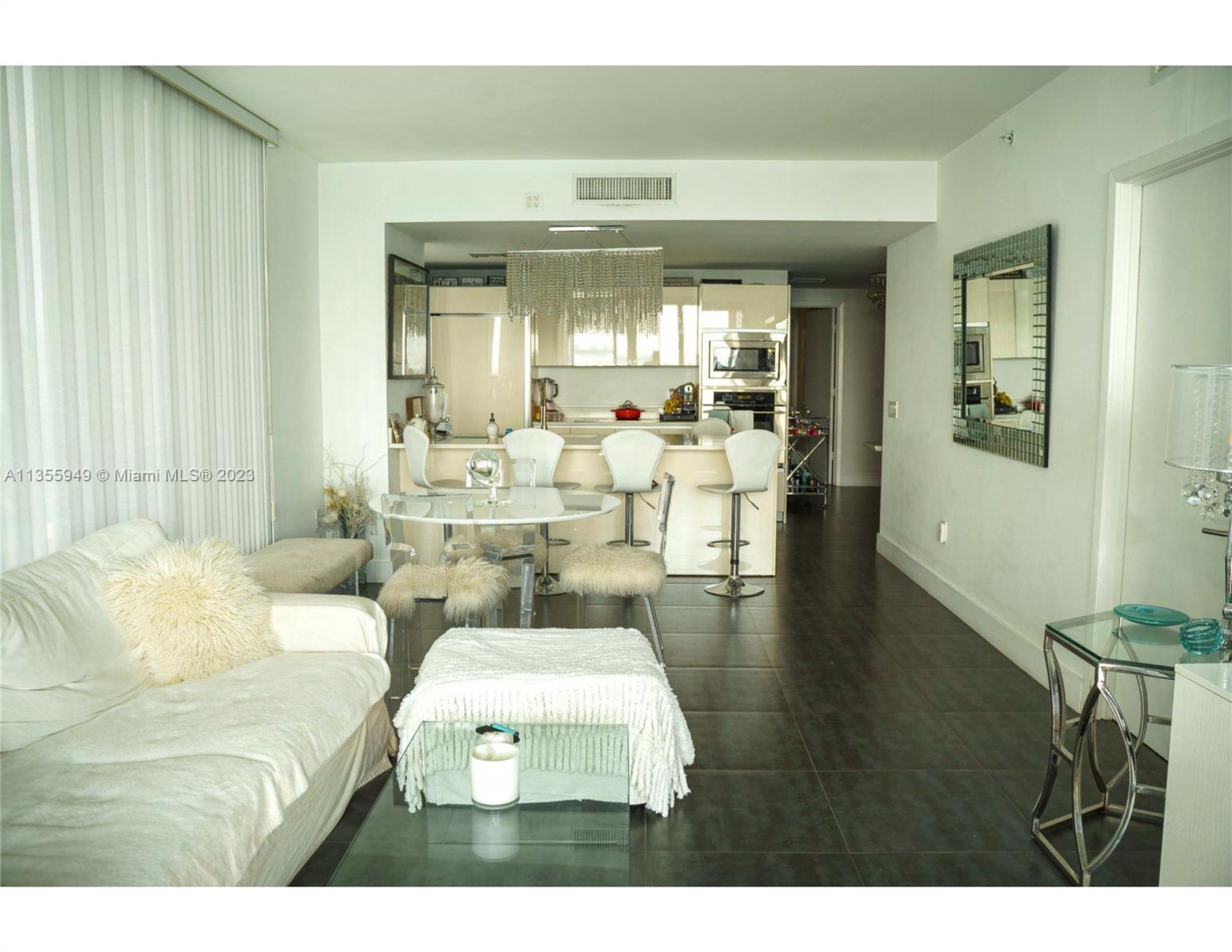 460 Northeast 28th Street, Unit 808 Miami, FL 33137 - Photo 7 of 20 a living room with furniture and a large window