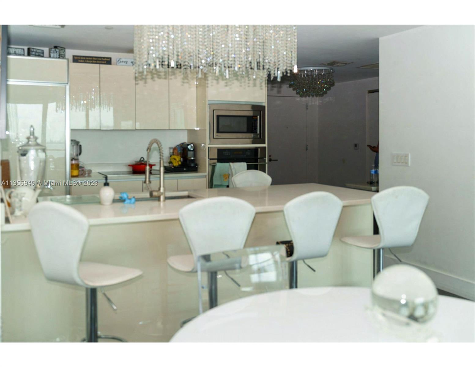 460 Northeast 28th Street, Unit 808 Miami, FL 33137 - Photo 9 of 20 a dining room with furniture and a fireplace