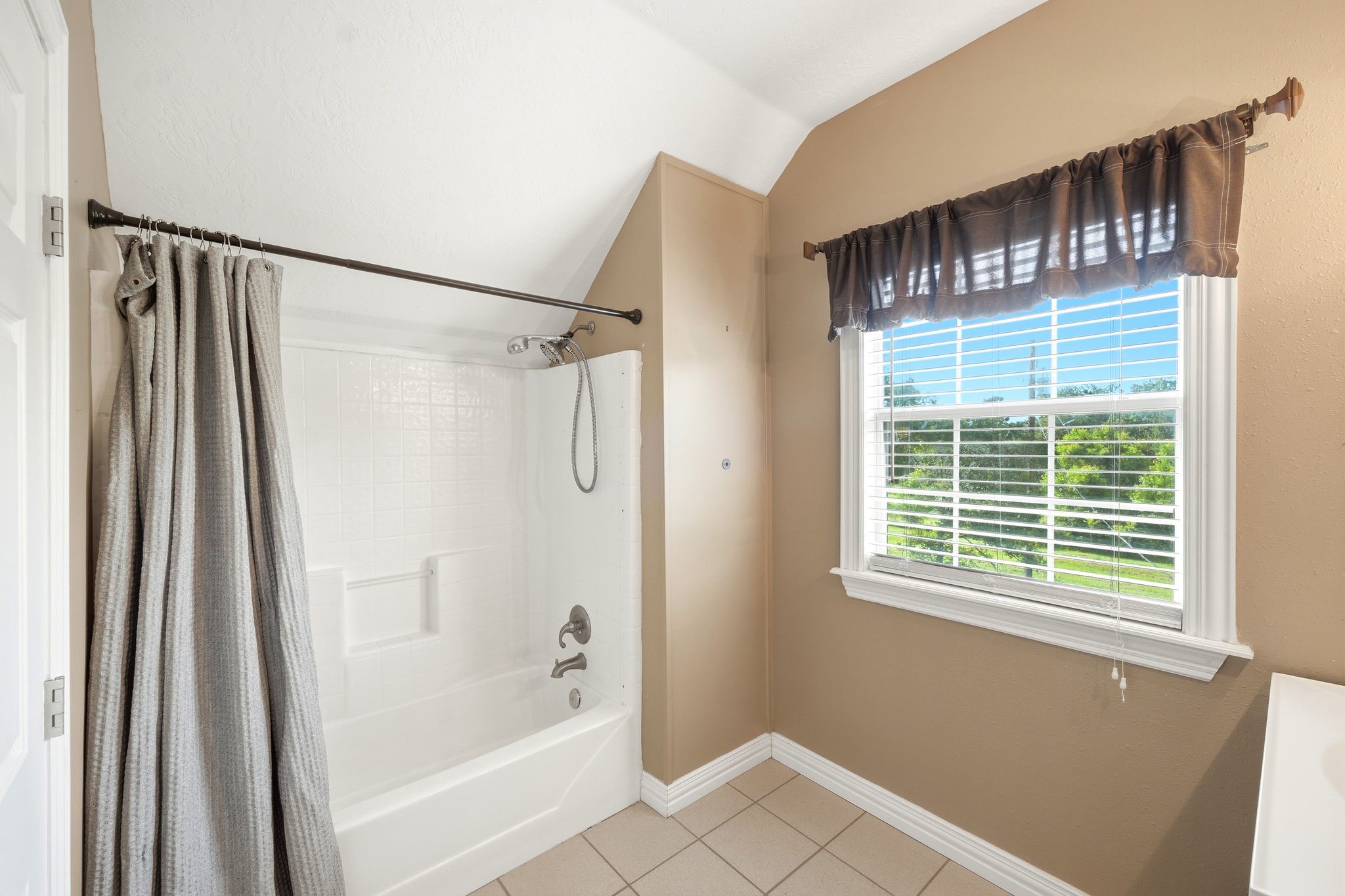 144 Wood Farm Road Huntsville, TX 77320 - Photo 31 of 50 a bath room with a window and a bath tub