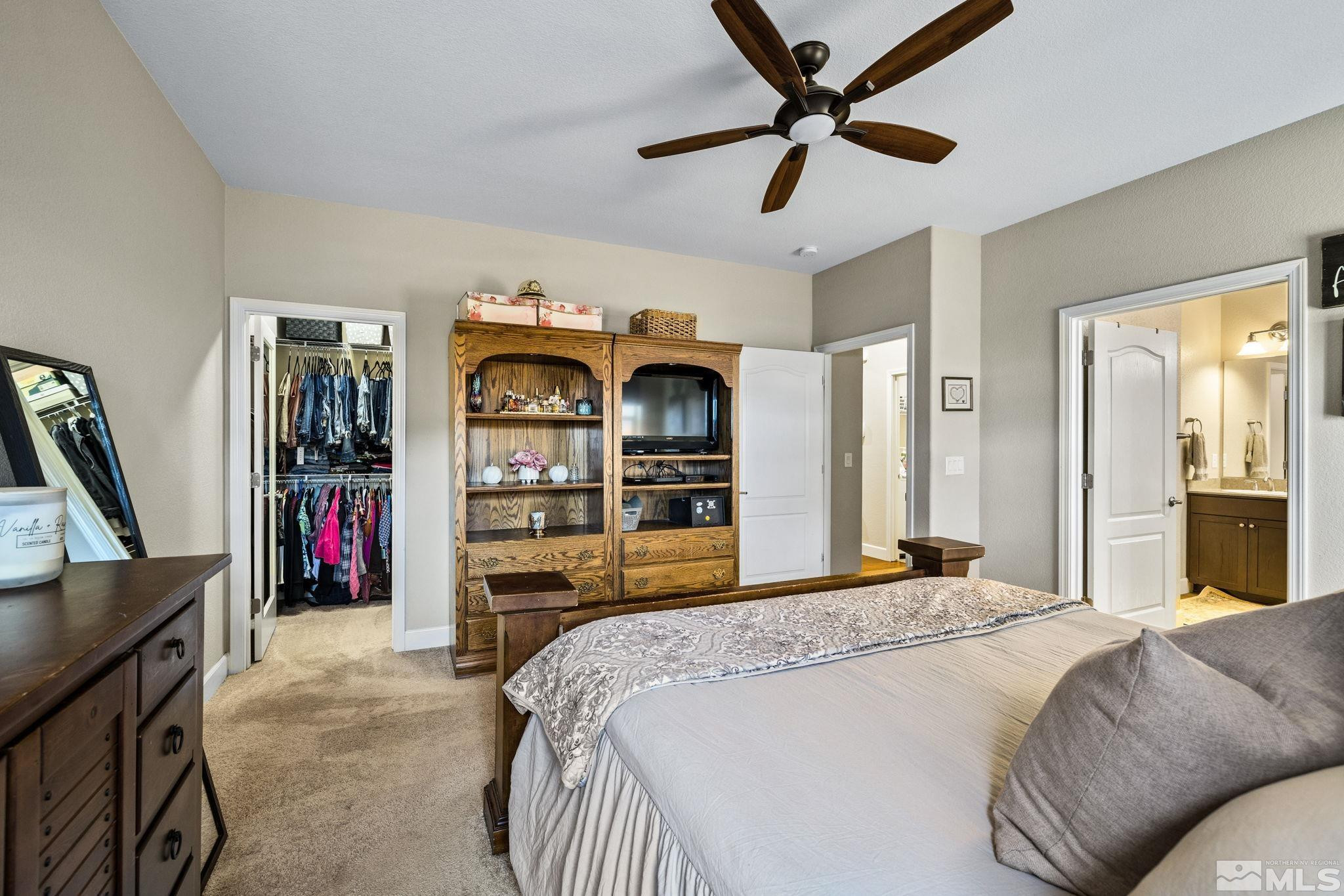 1735 Samantha Crest Trail Reno, NV 89523 - Photo 14 of 32 a bedroom with a large bed and a chandelier