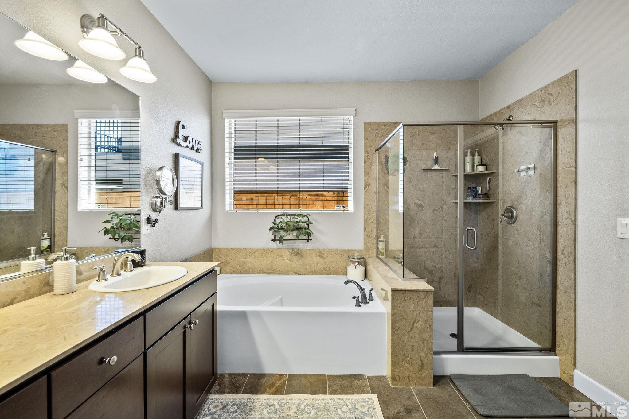 1735 Samantha Crest Trail Reno, NV 89523 - Photo 16 of 32 a bathroom with a tub sink shower and mirror