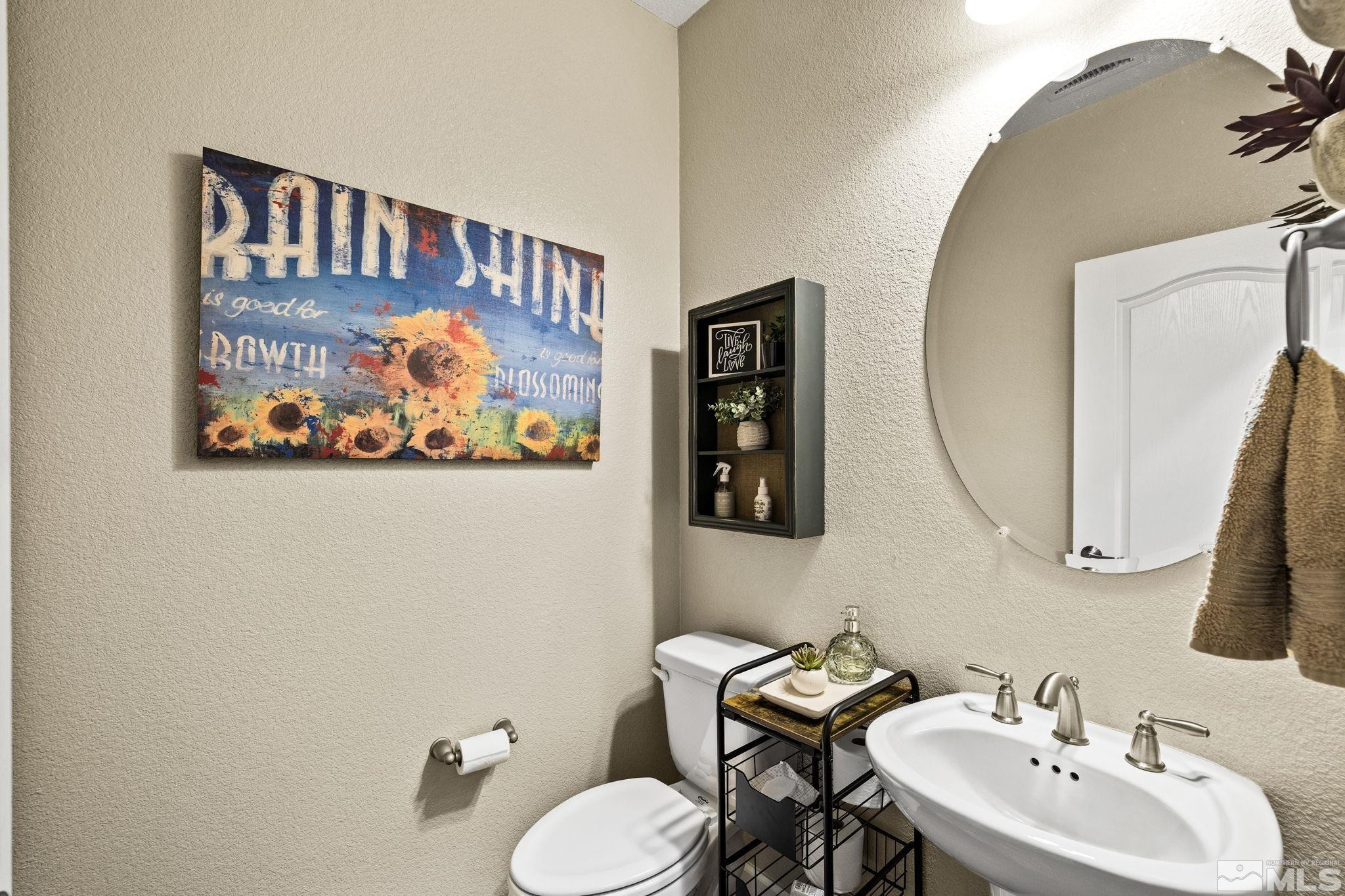 1735 Samantha Crest Trail Reno, NV 89523 - Photo 19 of 32 a bathroom with a toilet a sink and a mirror