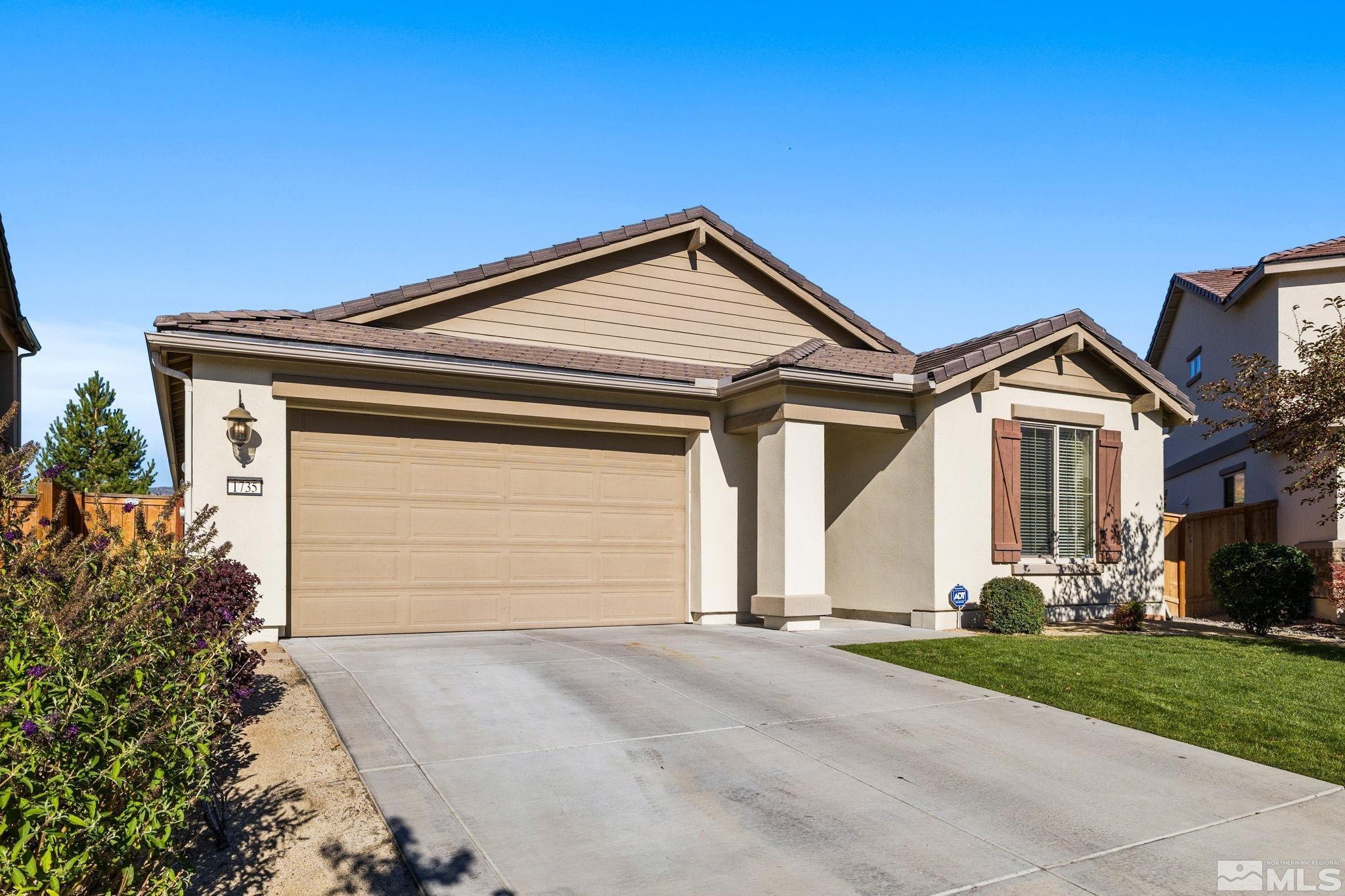 1735 Samantha Crest Trail Reno, NV 89523 - Photo 2 of 32 a front view of a house with garden