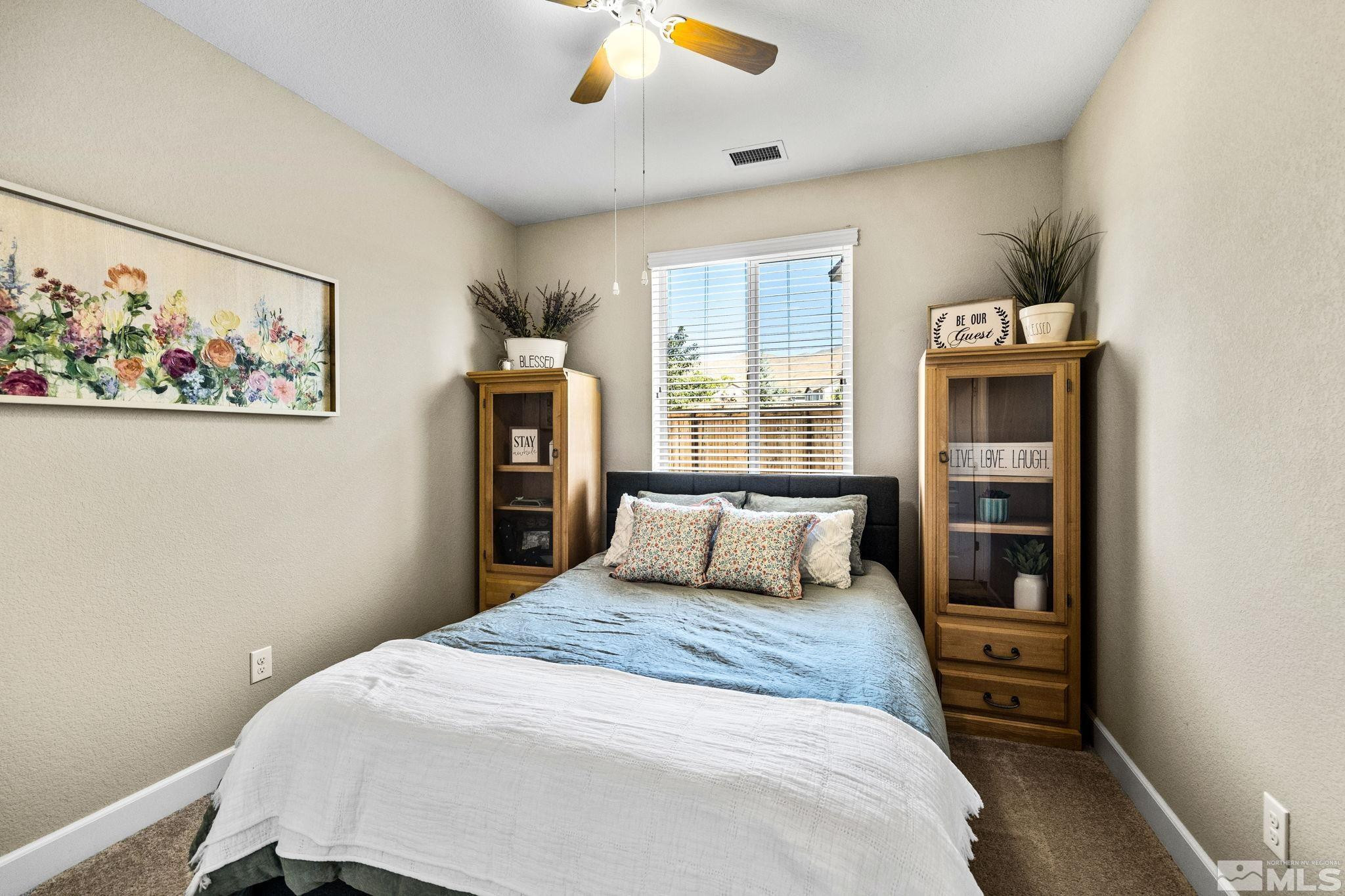 1735 Samantha Crest Trail Reno, NV 89523 - Photo 21 of 32 a bedroom with a large bed and a window
