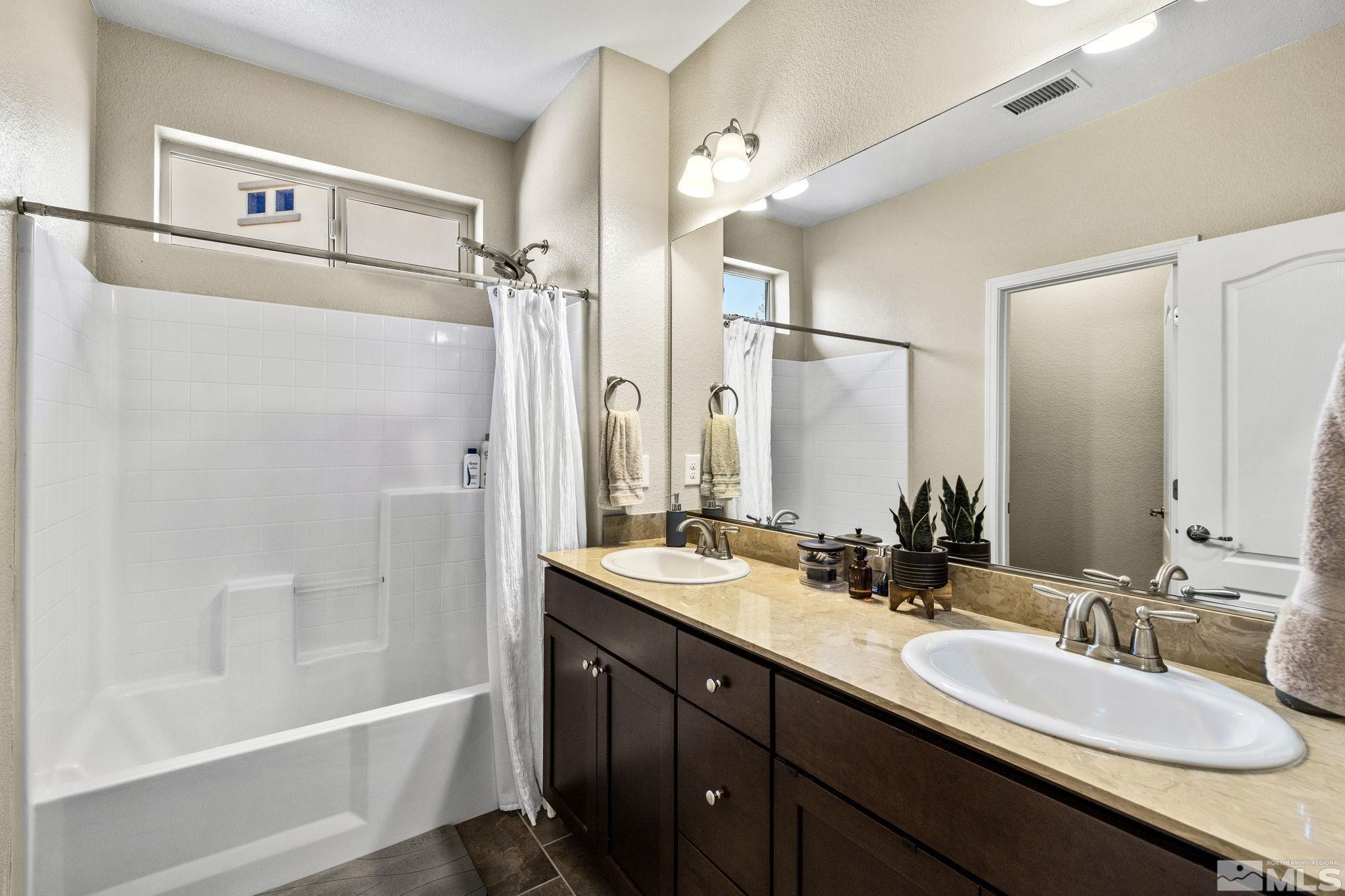 1735 Samantha Crest Trail Reno, NV 89523 - Photo 23 of 32 a bathroom with a tub a sink and mirror