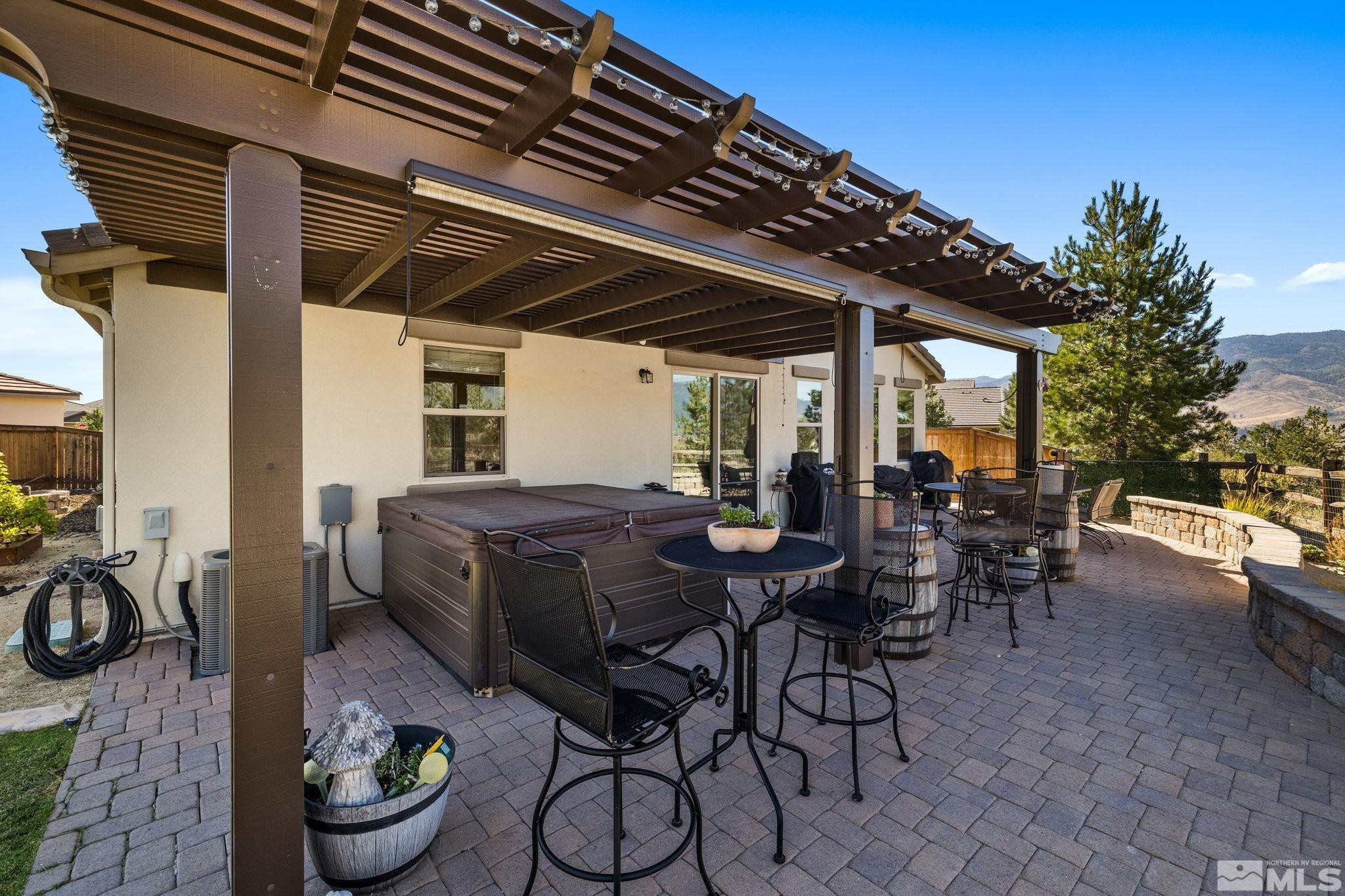 1735 Samantha Crest Trail Reno, NV 89523 - Photo 27 of 32 a view of a patio with table and chairs and potted plants