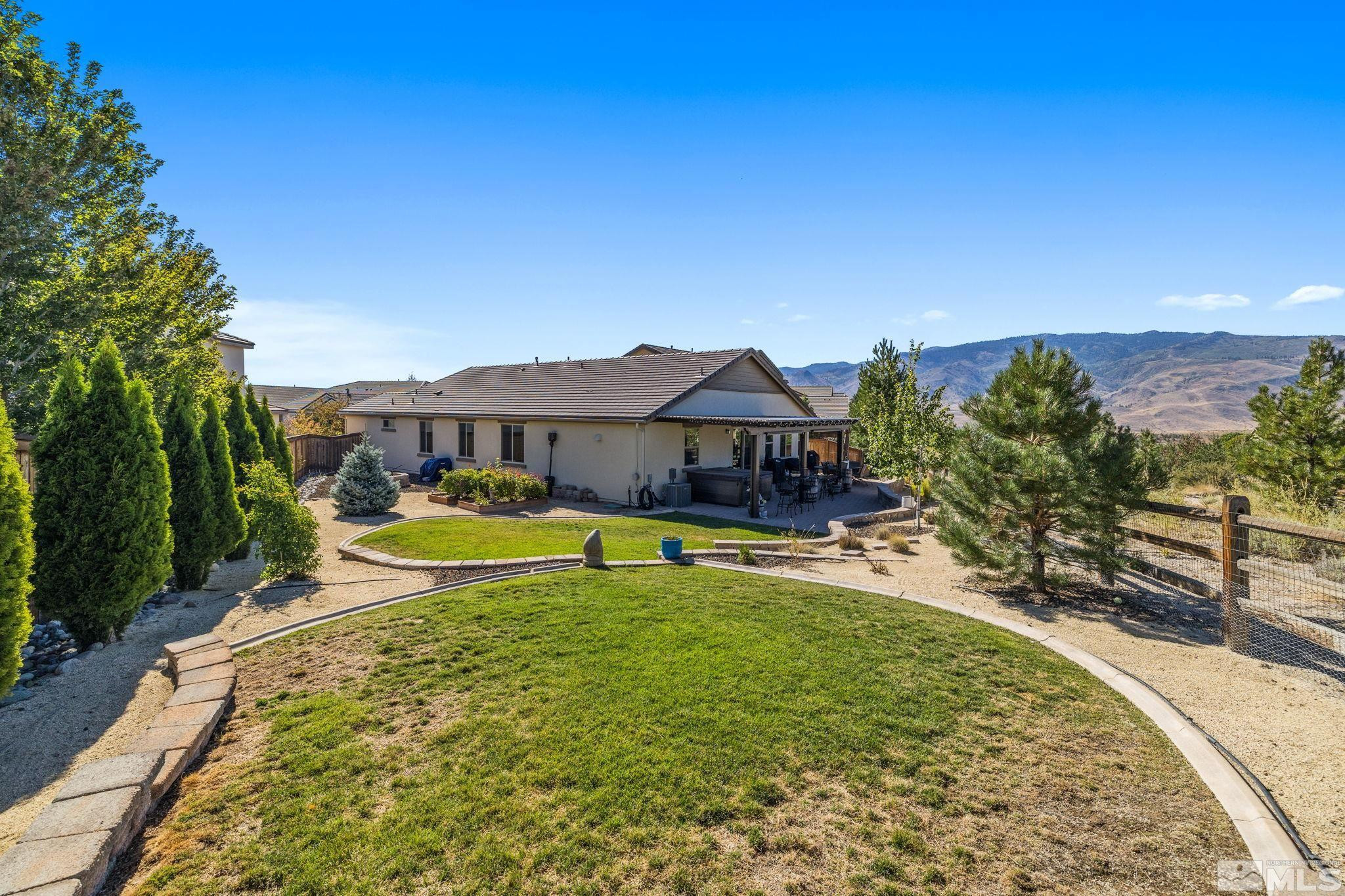 1735 Samantha Crest Trail Reno, NV 89523 - Photo 28 of 32 a view of a swimming pool with a garden and a small yard