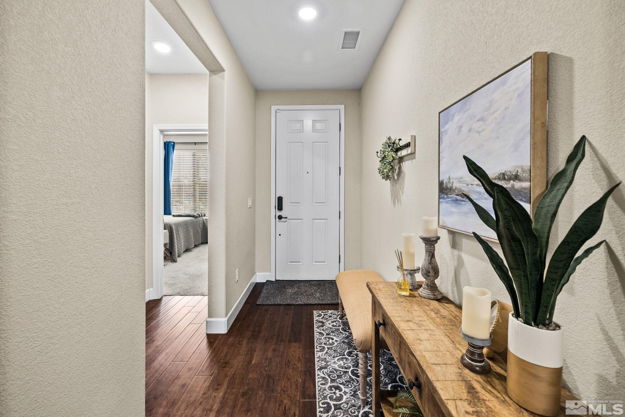 1735 Samantha Crest Trail Reno, NV 89523 - Photo 3 of 32 a view of a hallway with wooden floor and a potted plant
