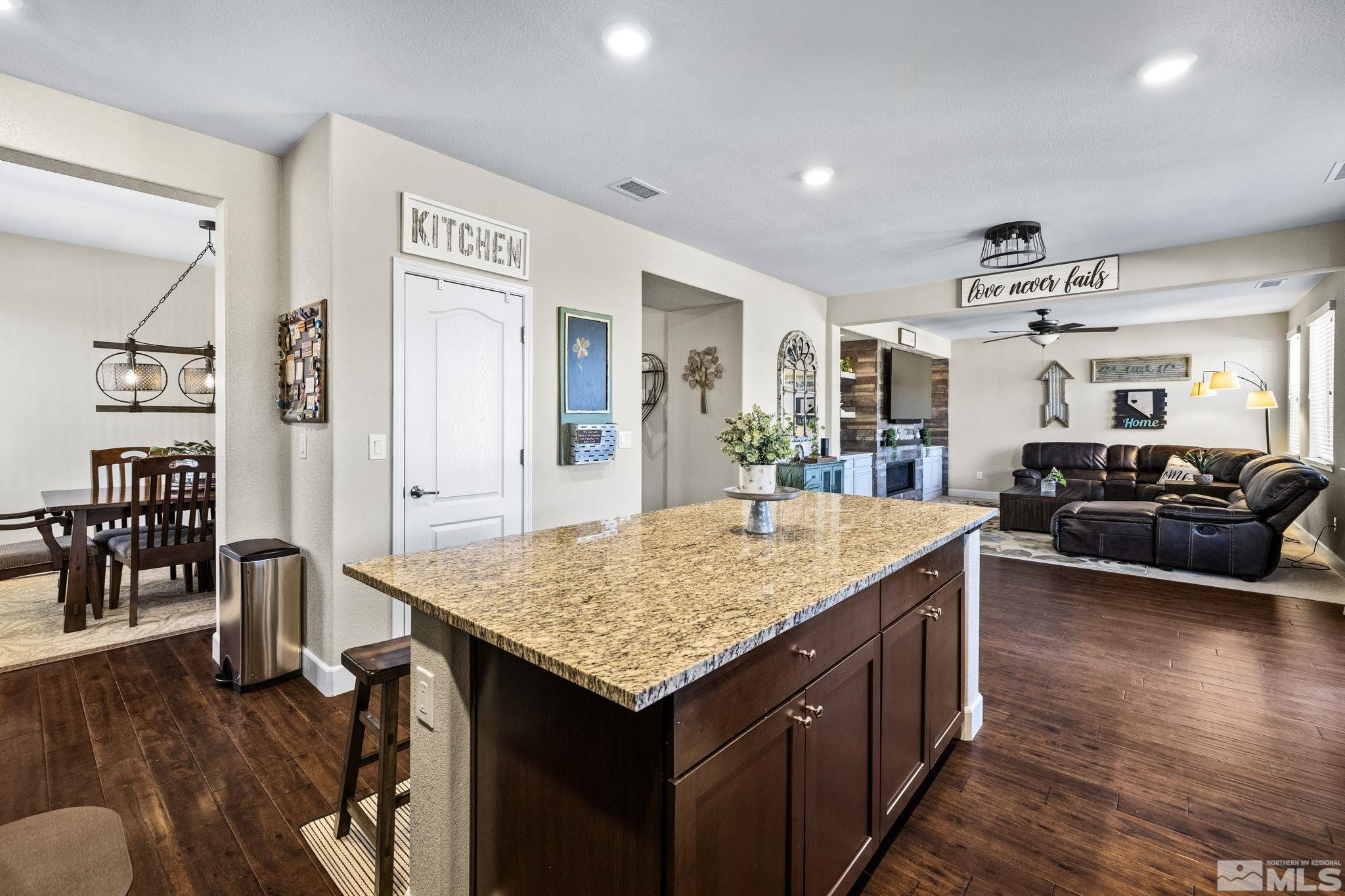 1735 Samantha Crest Trail Reno, NV 89523 - Photo 6 of 32 a living room with stainless steel appliances granite countertop wooden floor and kitchen view
