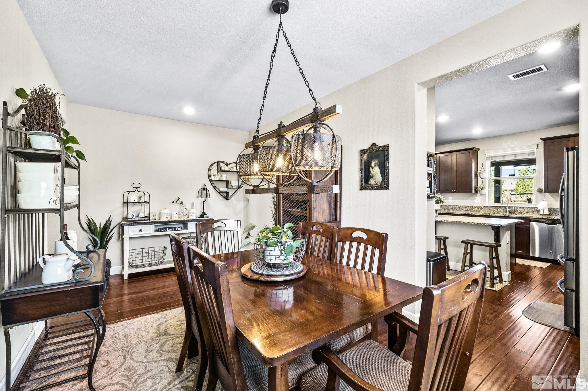 1735 Samantha Crest Trail Reno, NV 89523 - Photo 9 of 32 a dining room with furniture a chandelier and wooden floor