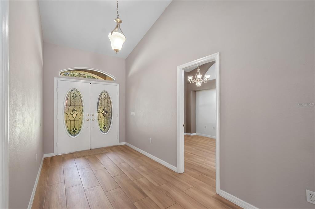 1969 Northwest 111th Loop Ocala, FL 34475 - Photo 16 of 48 a view of an empty room with wooden floor and a window