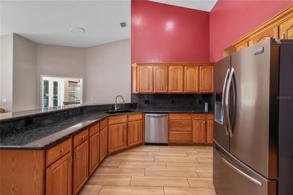 1969 Northwest 111th Loop Ocala, FL 34475 - Photo 21 of 48 a large kitchen with stainless steel appliances granite countertop a refrigerator and a sink