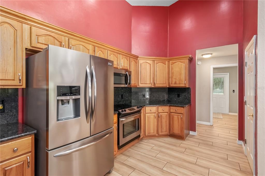 1969 Northwest 111th Loop Ocala, FL 34475 - Photo 23 of 48 a kitchen with granite countertop stainless steel appliances a refrigerator and cabinets