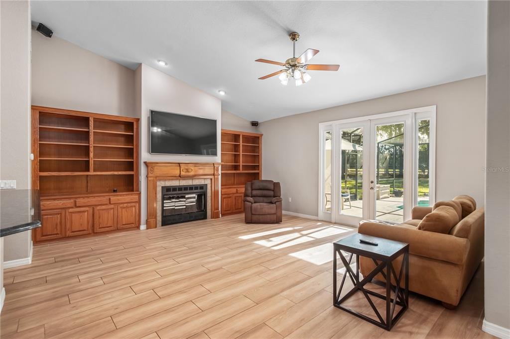 1969 Northwest 111th Loop Ocala, FL 34475 - Photo 27 of 48 a living room with furniture a flat screen tv and a fireplace