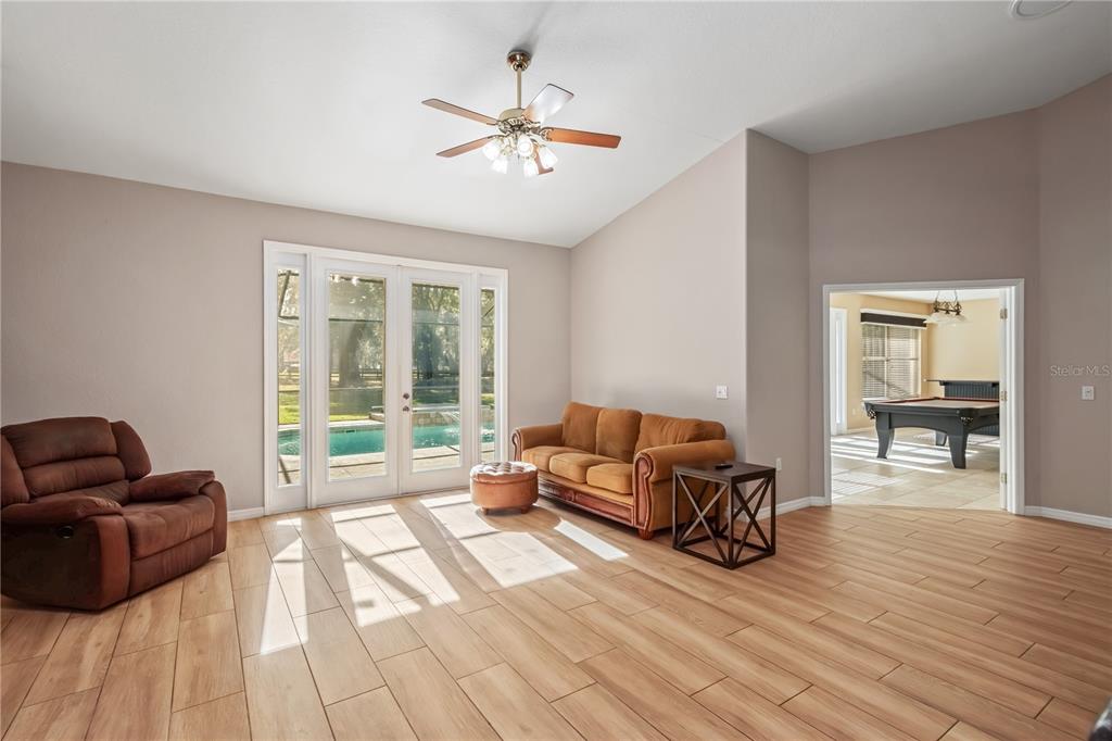 1969 Northwest 111th Loop Ocala, FL 34475 - Photo 28 of 48 a living room with furniture and a floor to ceiling window