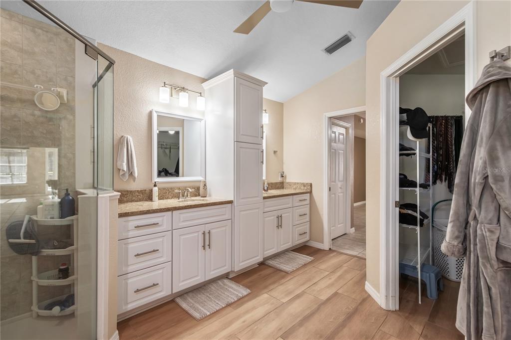 1969 Northwest 111th Loop Ocala, FL 34475 - Photo 40 of 48 a large bathroom with a double vanity sink a large mirror and shower