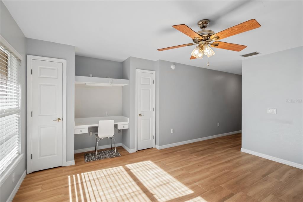 1969 Northwest 111th Loop Ocala, FL 34475 - Photo 44 of 48 a bedroom with a bed and a chandelier