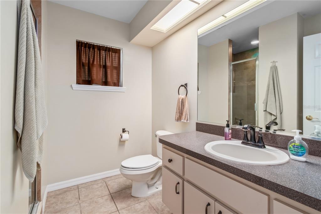 1969 Northwest 111th Loop Ocala, FL 34475 - Photo 45 of 48 a bathroom with a granite countertop sink toilet and mirror