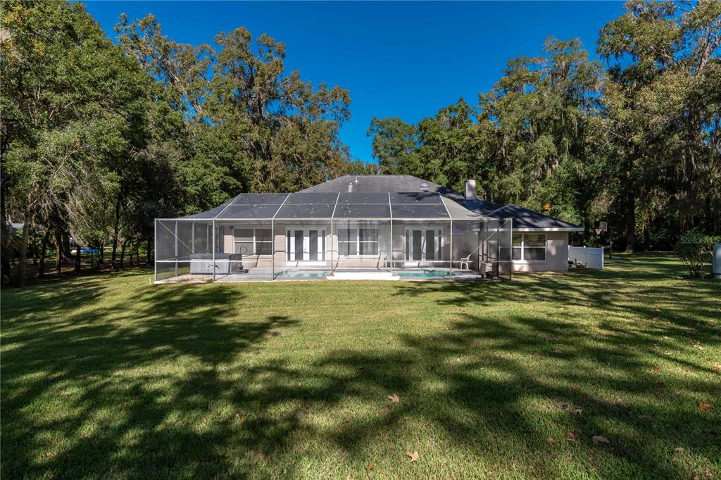 1969 Northwest 111th Loop Ocala, FL 34475 - Photo 6 of 48 a front view of house with yard and trees in the background