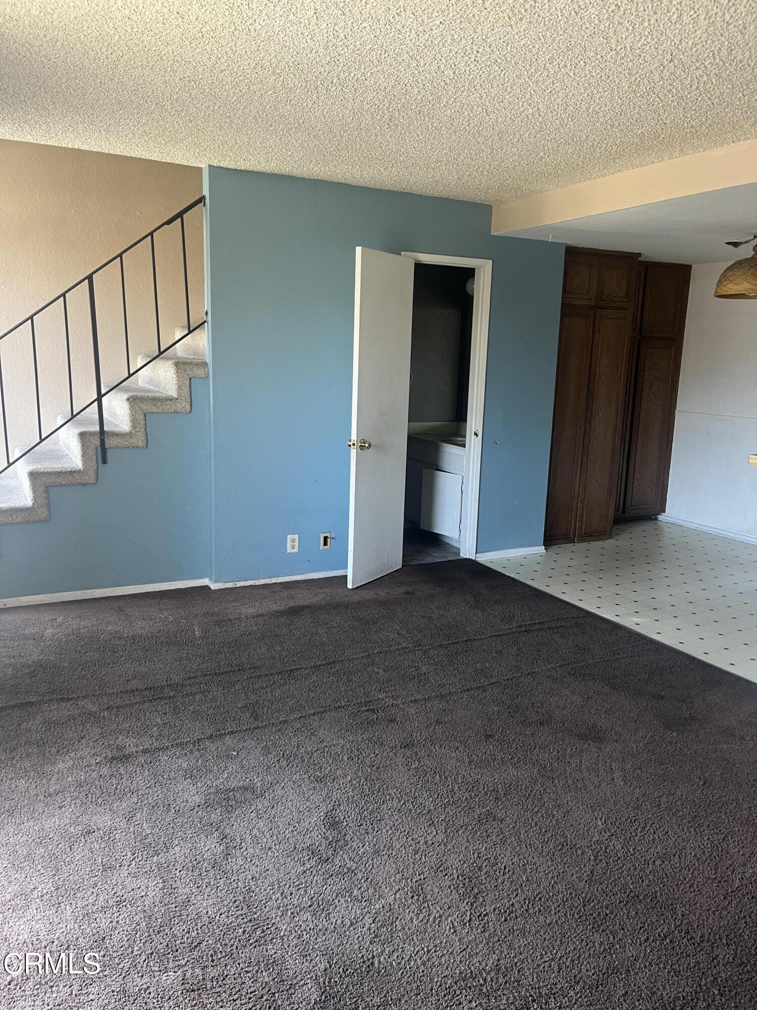 4588 Saviers Road Oxnard, CA 93033 - Photo 2 of 6 a view of an empty room with stairs