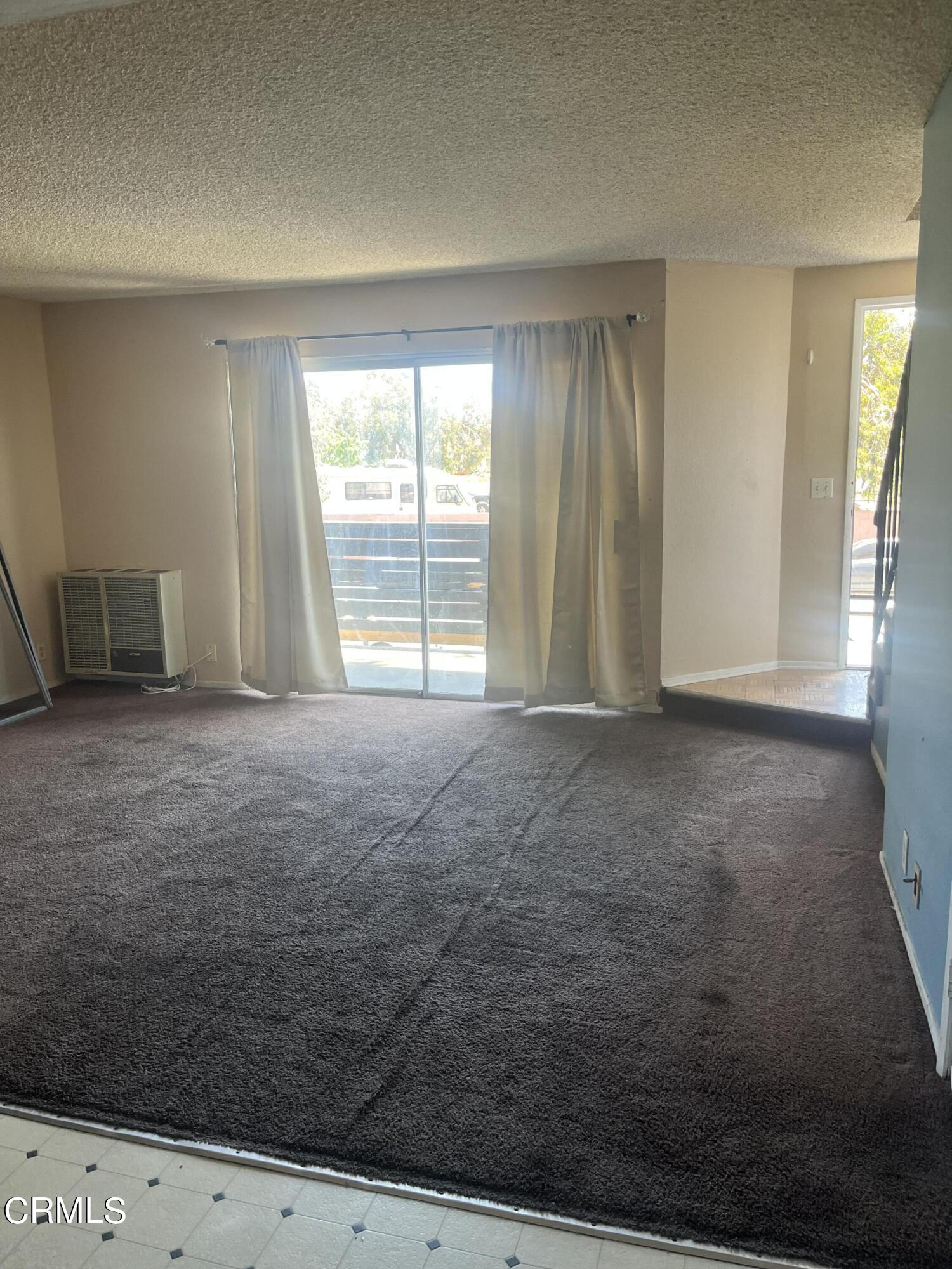 4588 Saviers Road Oxnard, CA 93033 - Photo 3 of 6 a view of an empty room with a fireplace