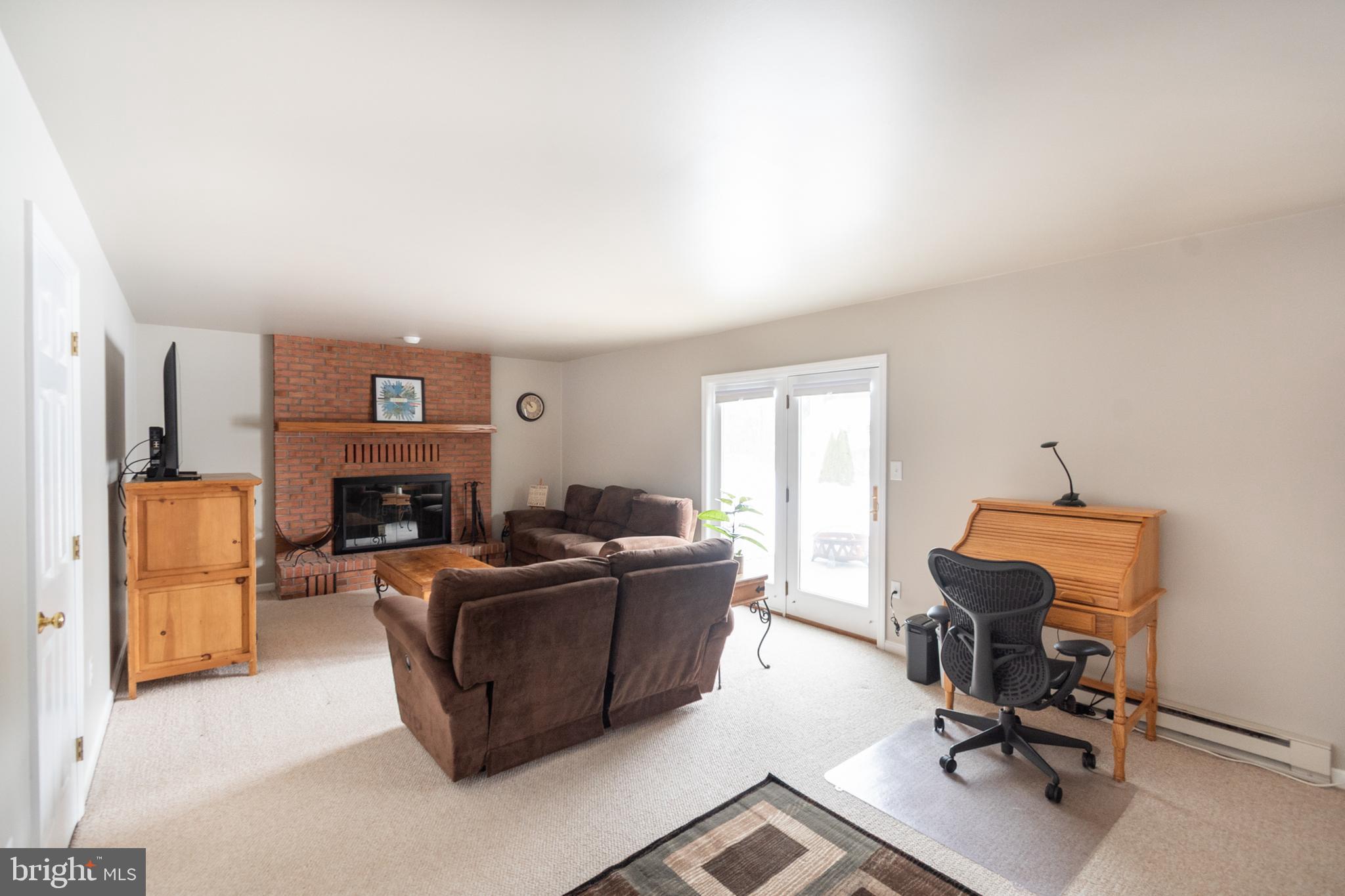 1469 Chaumont Avenue State College, PA 16801 - Photo 15 of 50 a living room with furniture a fireplace and a flat screen tv