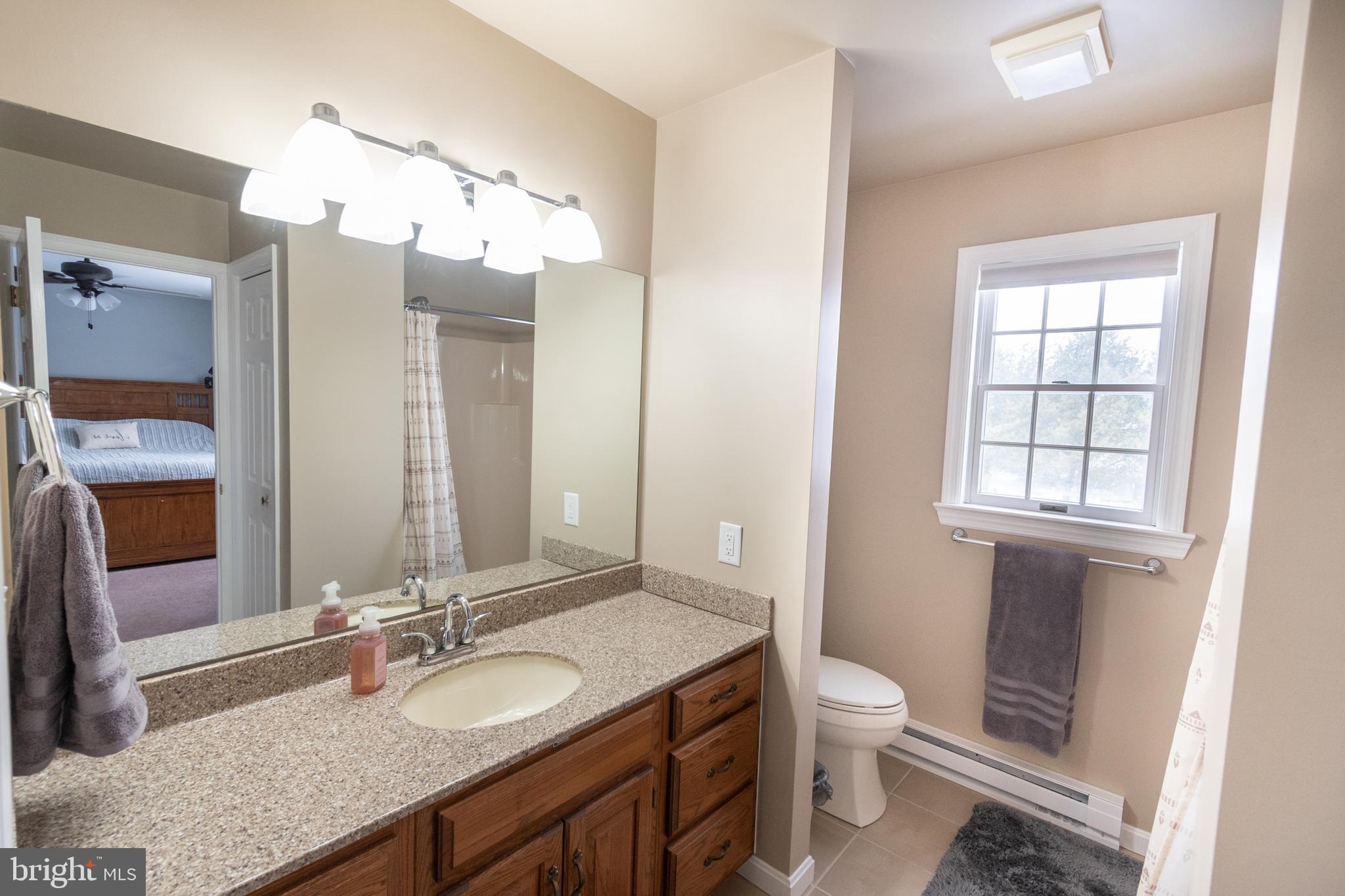 1469 Chaumont Avenue State College, PA 16801 - Photo 26 of 50 a bathroom with a granite countertop double vanity sink and a mirror